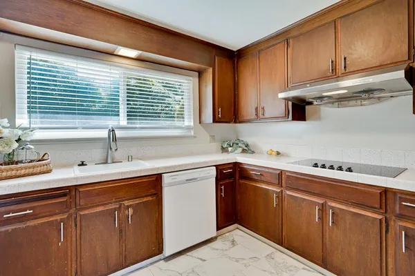 a kitchen with a sink cabinets and window