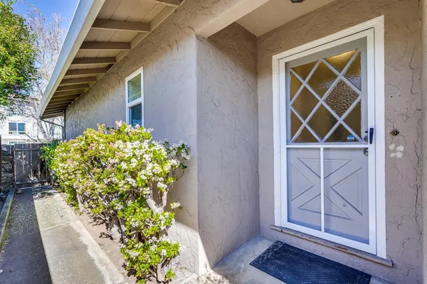 a view of hallway with windows and wooden floor