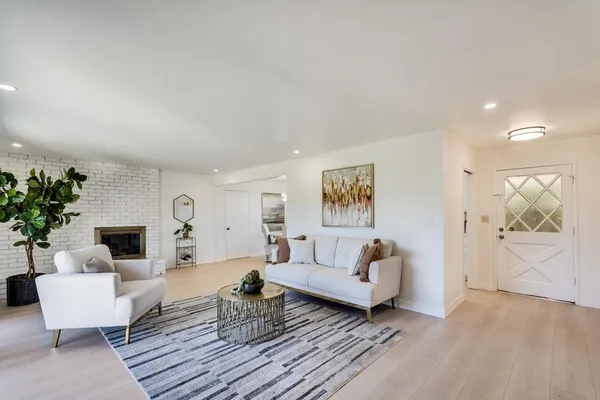 a dining room with furniture potted plants and wooden floor