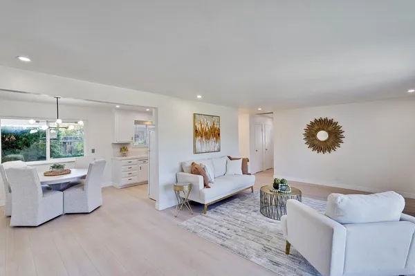 a bedroom with a large bed and a potted plant