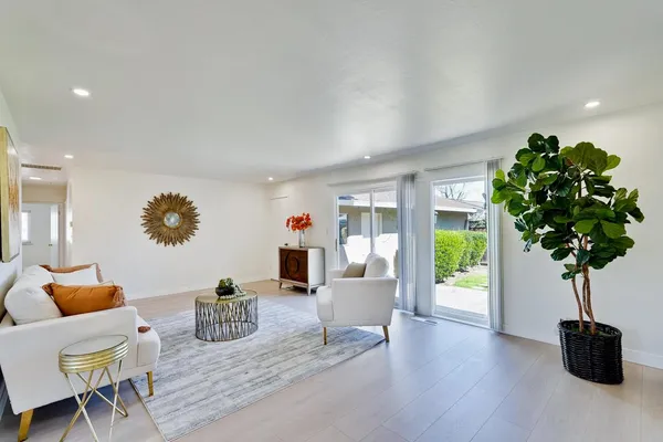 a bedroom with a bed and a painting on the wall