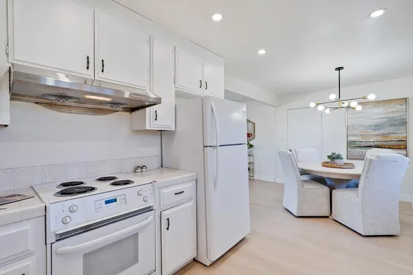 a bedroom with a bed and a potted plant