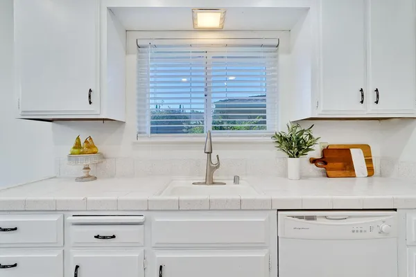 a bathroom with a double vanity sink mirror and toilet