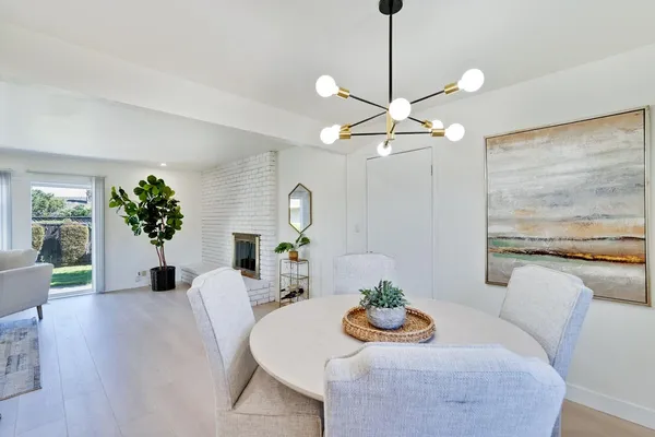 a front view of a house with garden and a tree