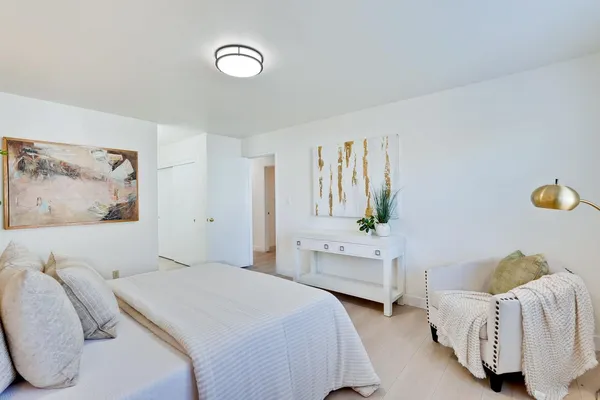 a front view of a house with a yard and potted plants