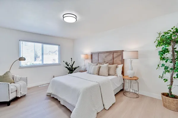 a view of a grassy field with trees in the background