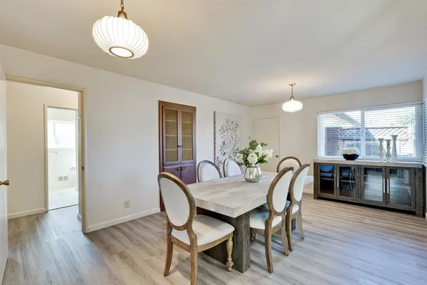 a view of a dining room with furniture window and wooden floor