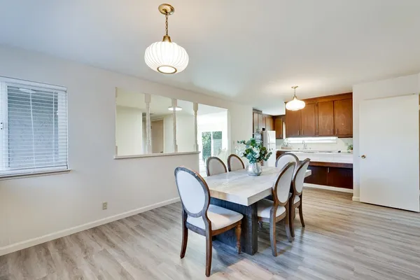 a view of a dining room with furniture and wooden floor