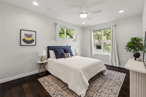 a bedroom with a bed and a painting on the wall