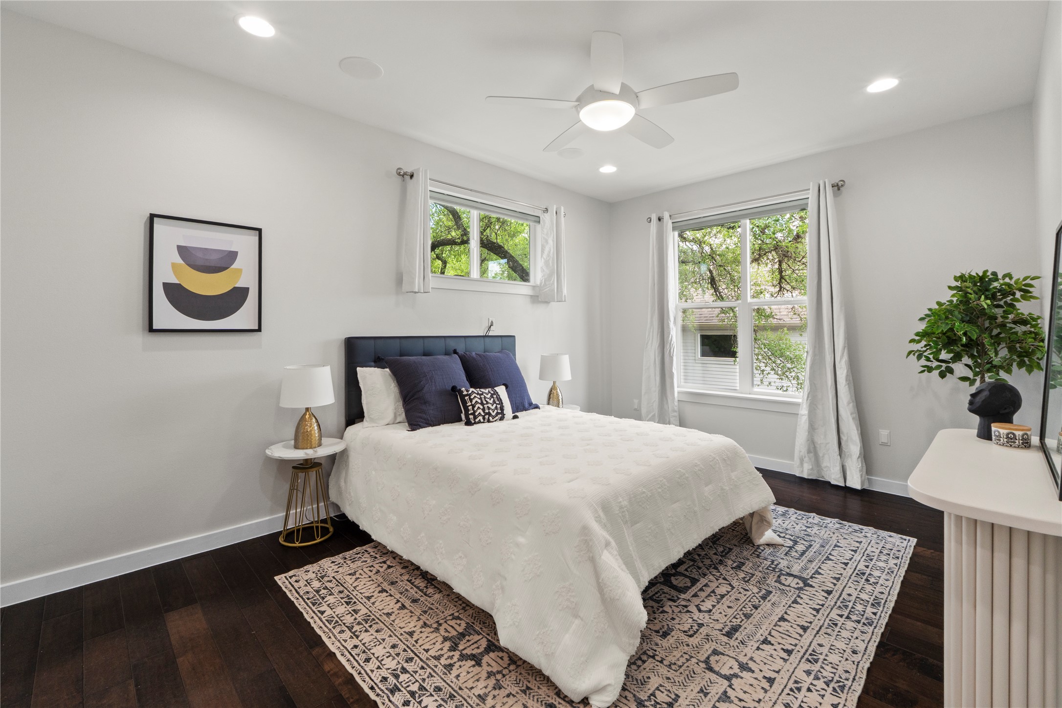 3001 Del Curto Road, Unit 35 Austin, TX 78704 - Photo 12 of 22 This room features dark hardwood floors, white walls, and bright windows allowing for natural light