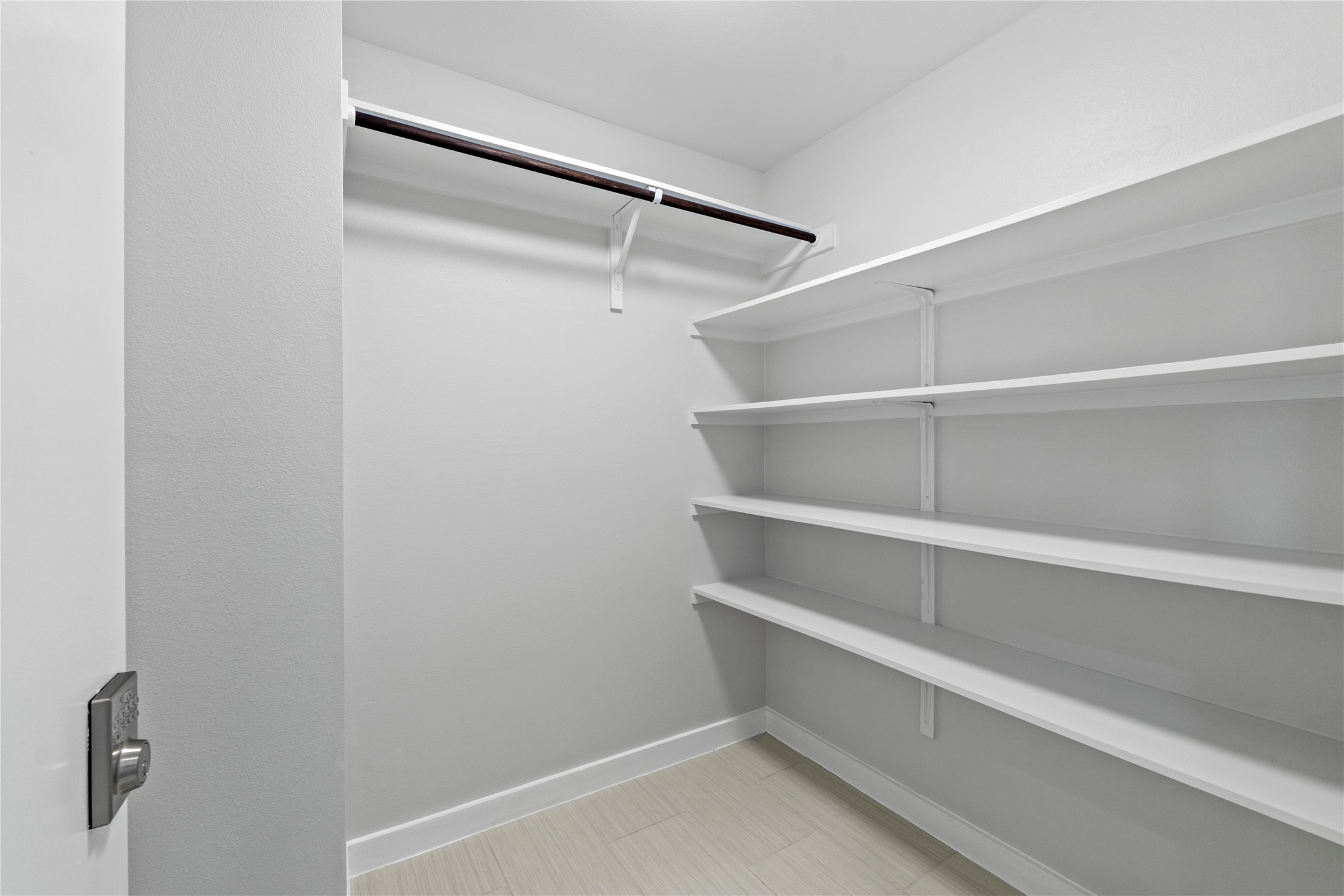 3001 Del Curto Road, Unit 35 Austin, TX 78704 - Photo 14 of 22 Spacious closet featuring built-in shelving, a hanging rod, and light-toned flooring