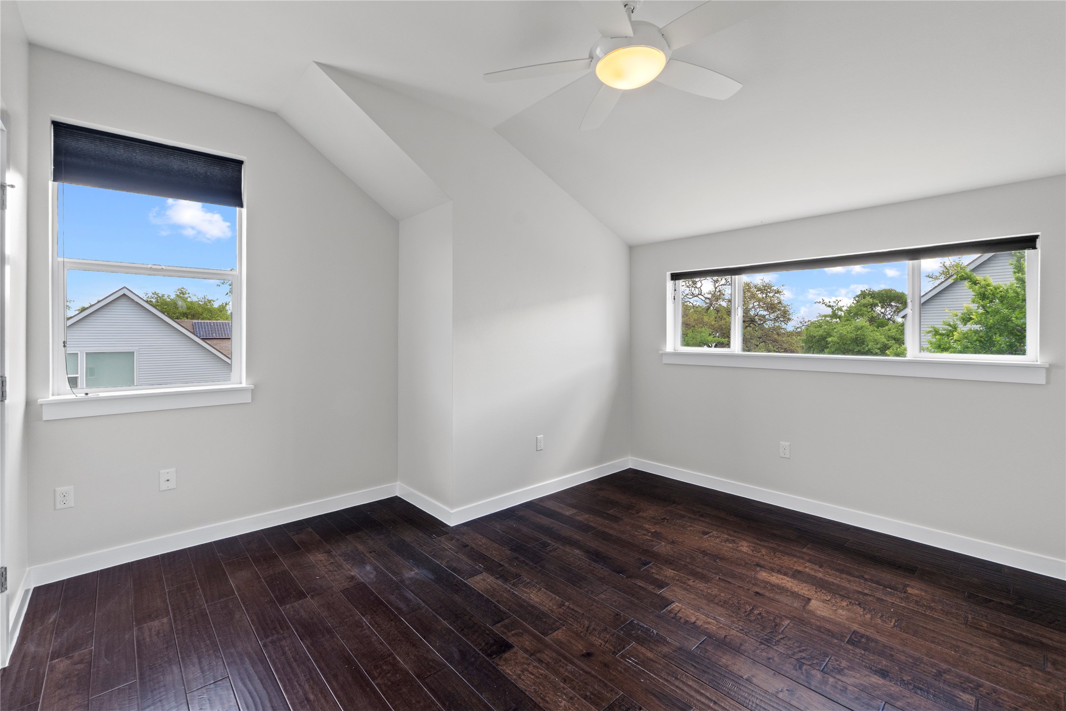 3001 Del Curto Road, Unit 35 Austin, TX 78704 - Photo 15 of 22 This room features rich hardwood floors, an angled ceiling, and large windows with privacy blinds