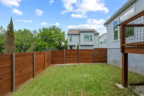 a backyard of a house with wooden fence