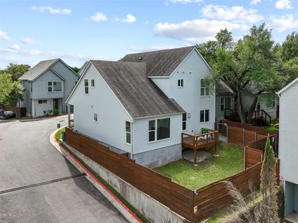 a front view of a house with garden and chairs