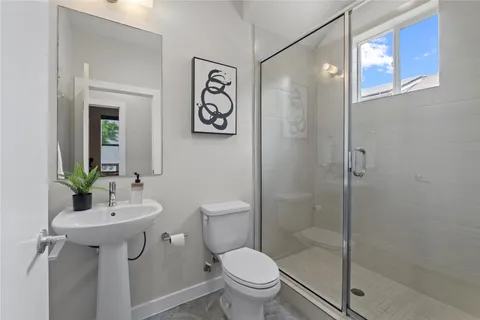 a bathroom with a toilet sink and shower