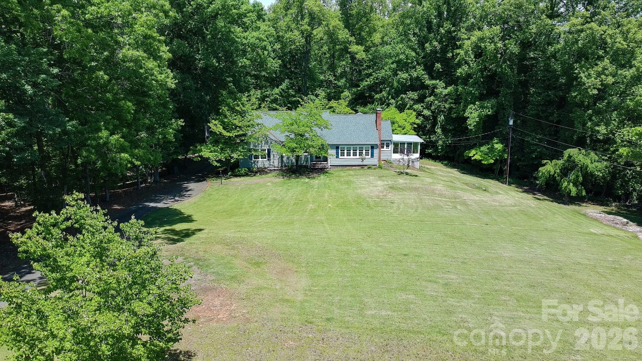 951 Dodson Mill Road Pilot Mountain, NC 27041 - Photo 40 of 48 a yellow house with trees in front of it