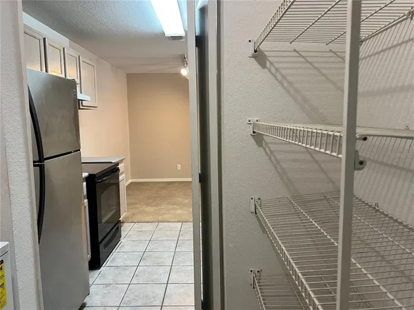 a bathroom with a walk in closet and wooden floor
