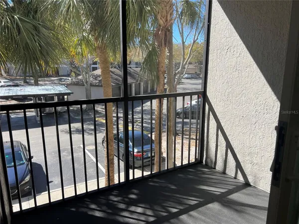a view of balcony with wooden floor and fence