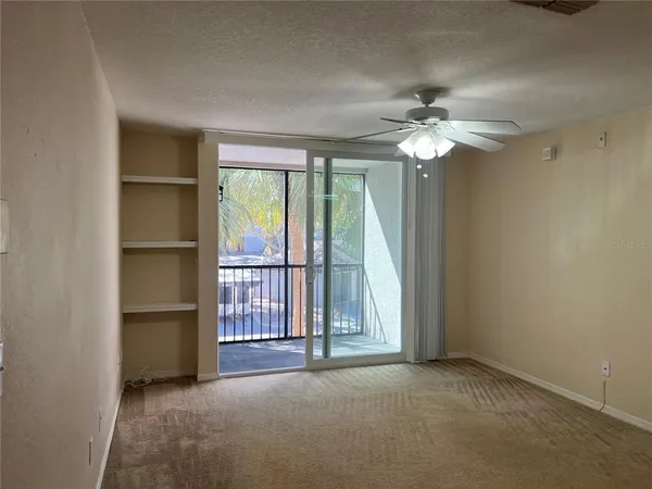 a view of empty room with ceiling fan