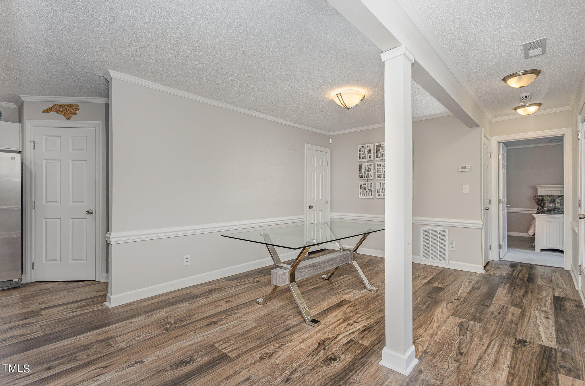 7040 Sandy Forks Road, Unit 203 Raleigh, NC 27615 - Photo 12 of 30 a view of a room with wooden floor and chairs