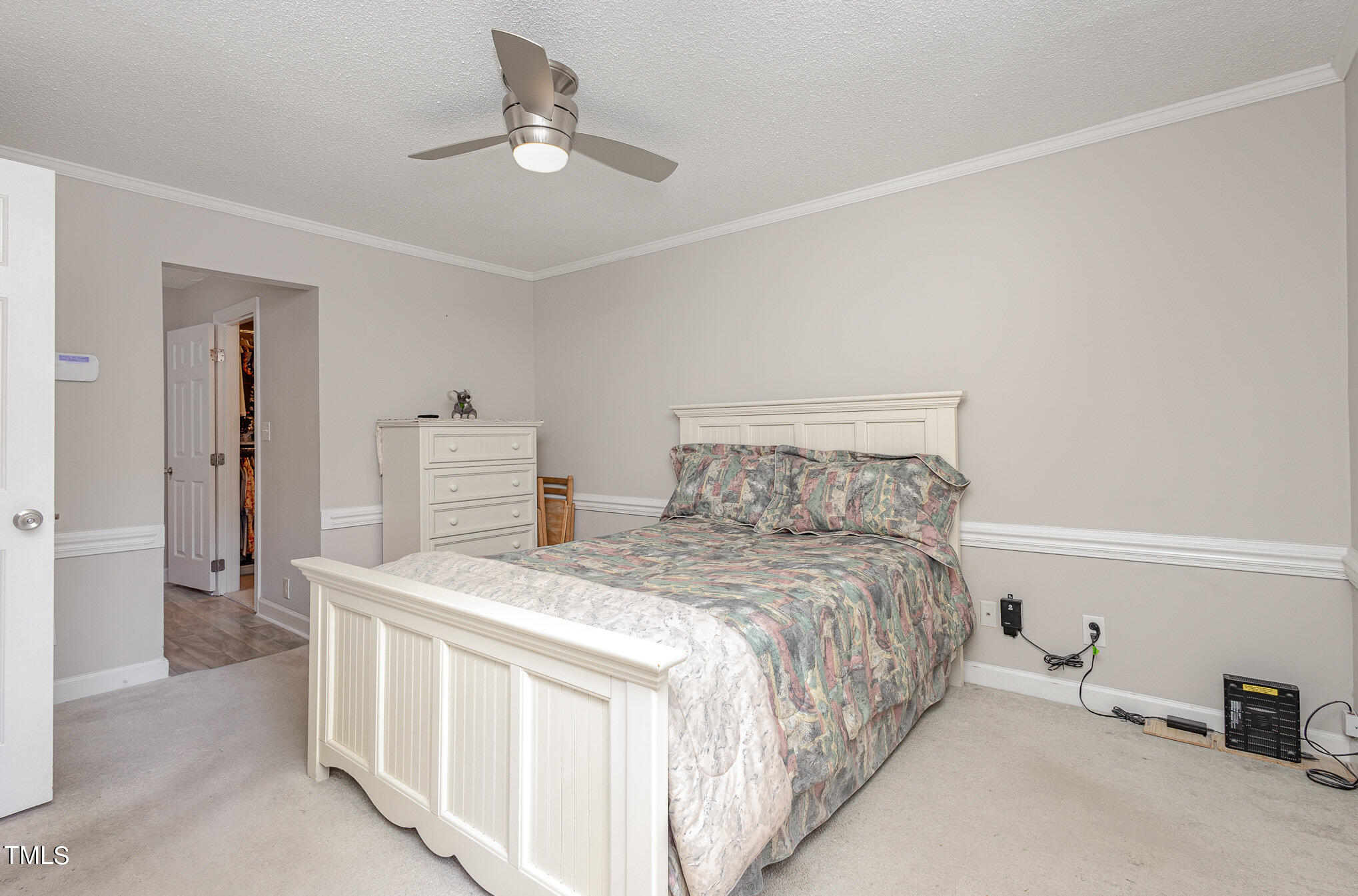 7040 Sandy Forks Road, Unit 203 Raleigh, NC 27615 - Photo 18 of 30 a bedroom with a bed and a chandelier