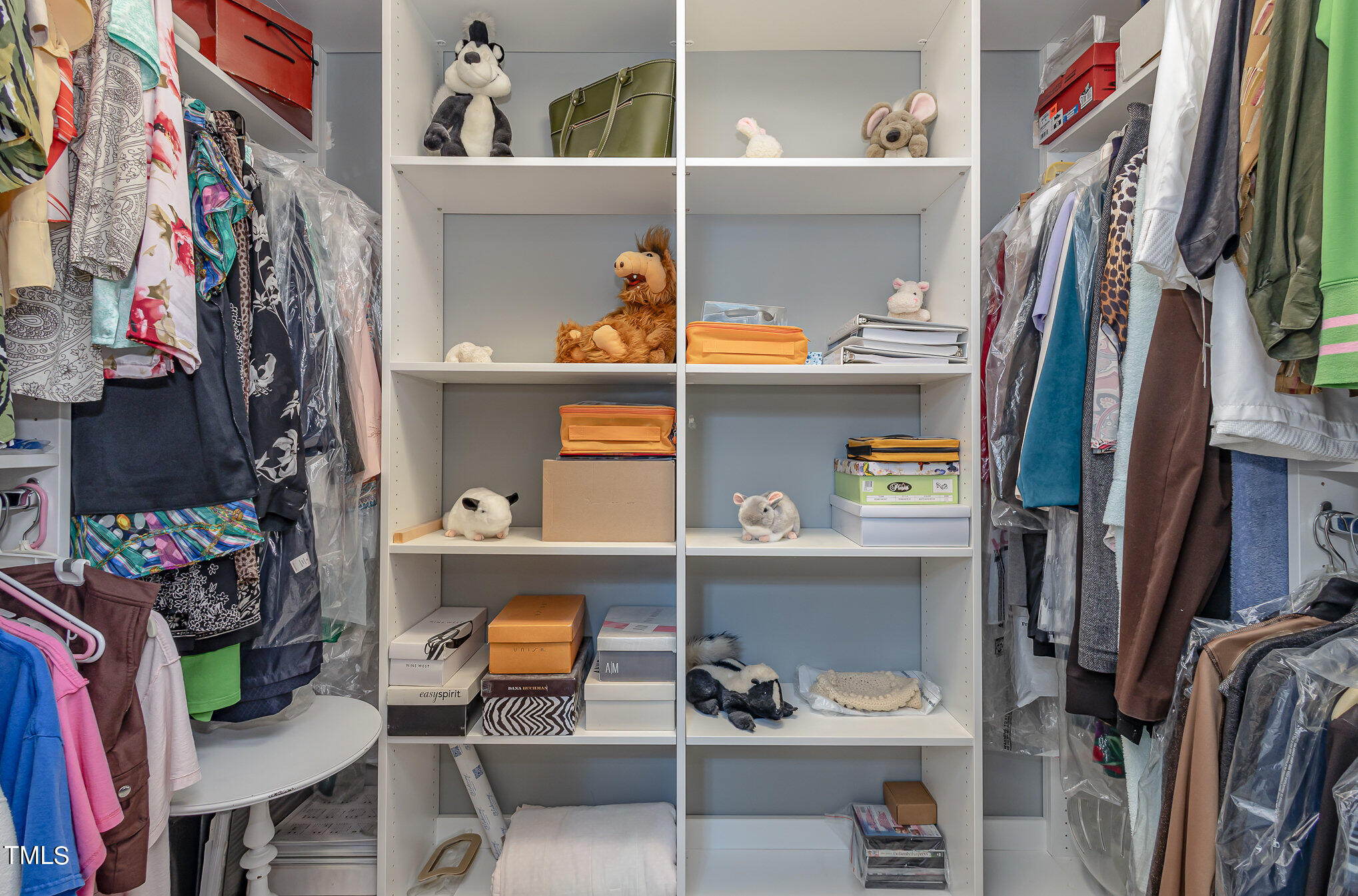 7040 Sandy Forks Road, Unit 203 Raleigh, NC 27615 - Photo 23 of 30 a view of walk in closet with clothes and shoes