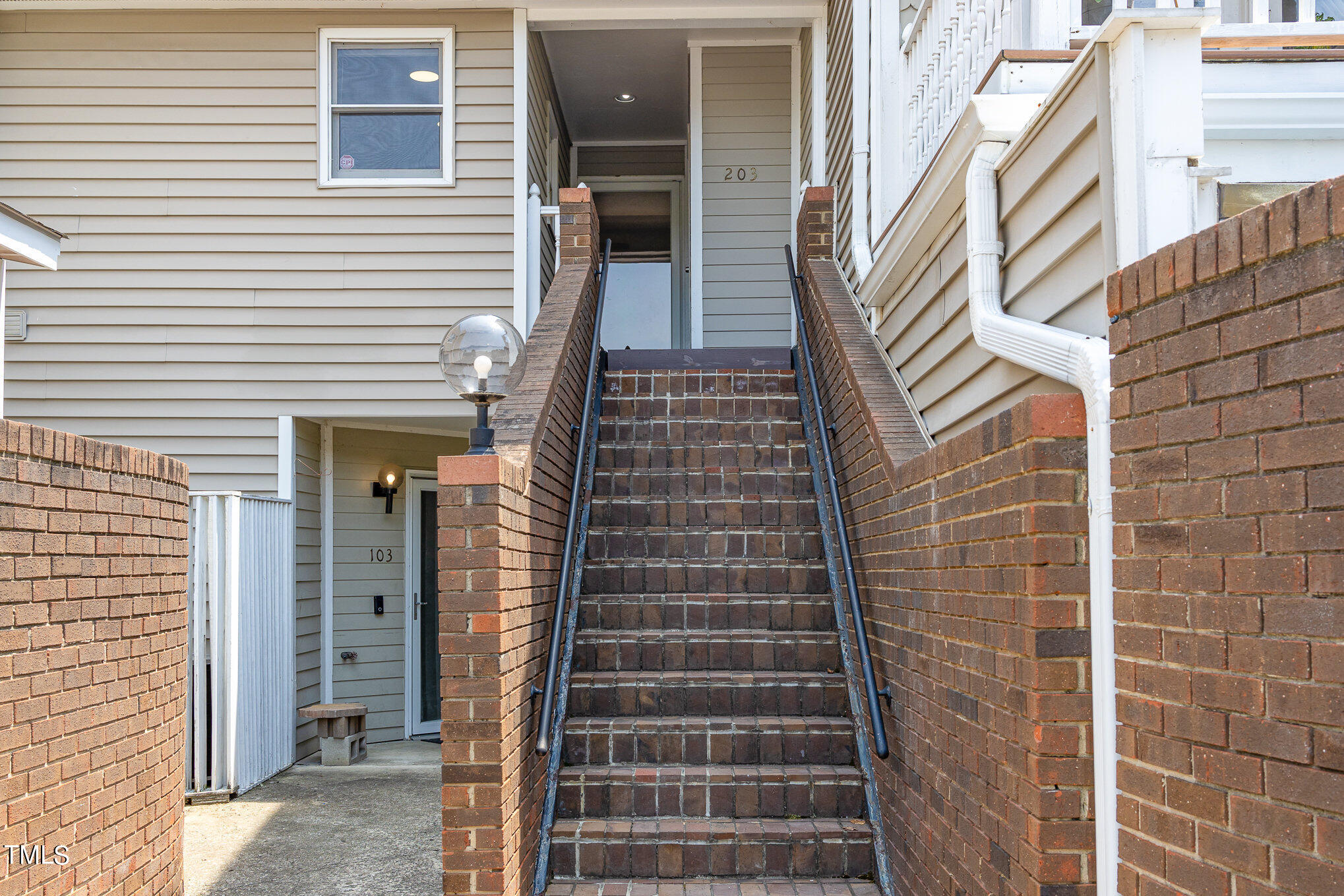 7040 Sandy Forks Road, Unit 203 Raleigh, NC 27615 - Photo 4 of 30 a view of a brick buildings with entryway