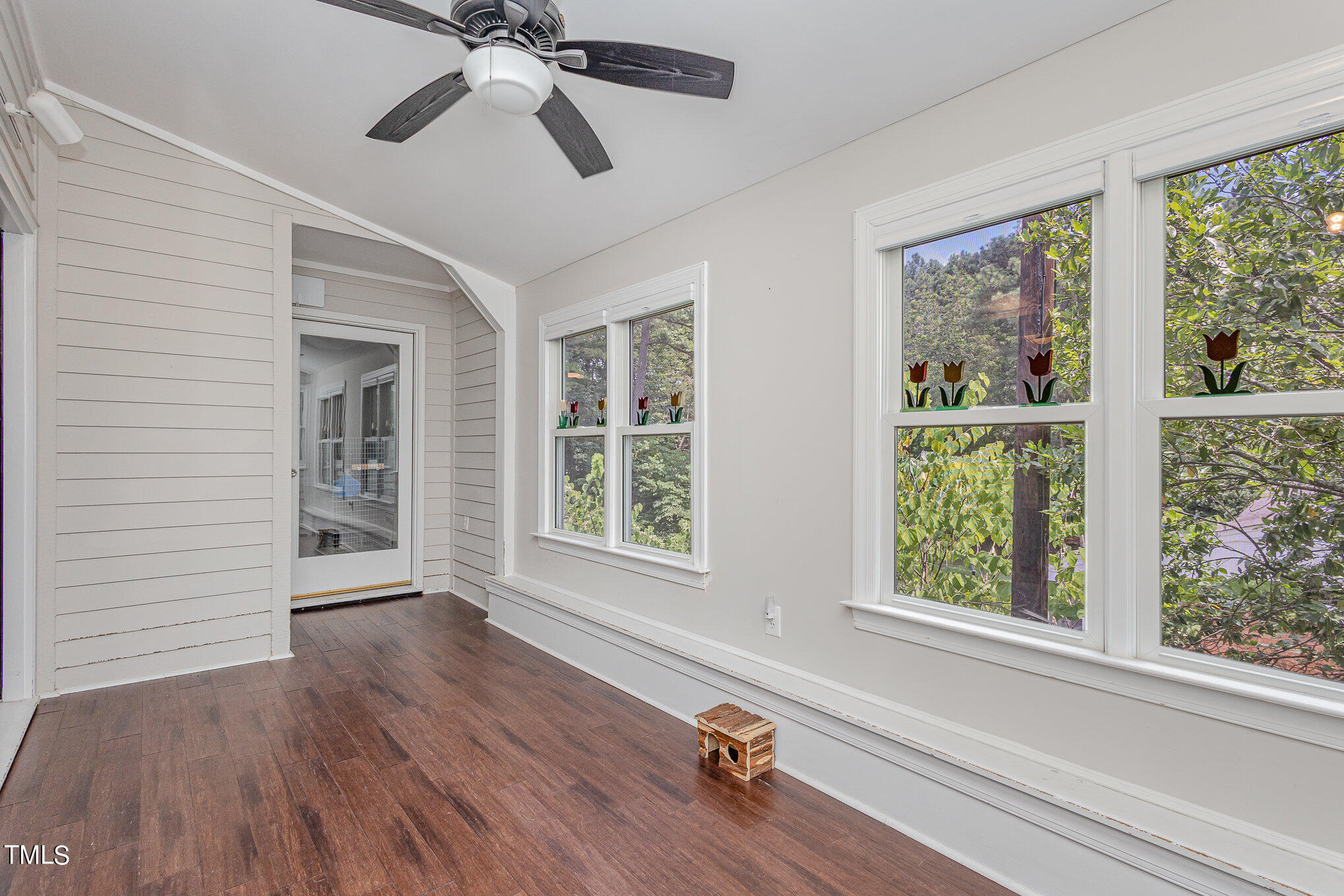 7040 Sandy Forks Road, Unit 203 Raleigh, NC 27615 - Photo 7 of 30 a view of an empty room with wooden floor and a window