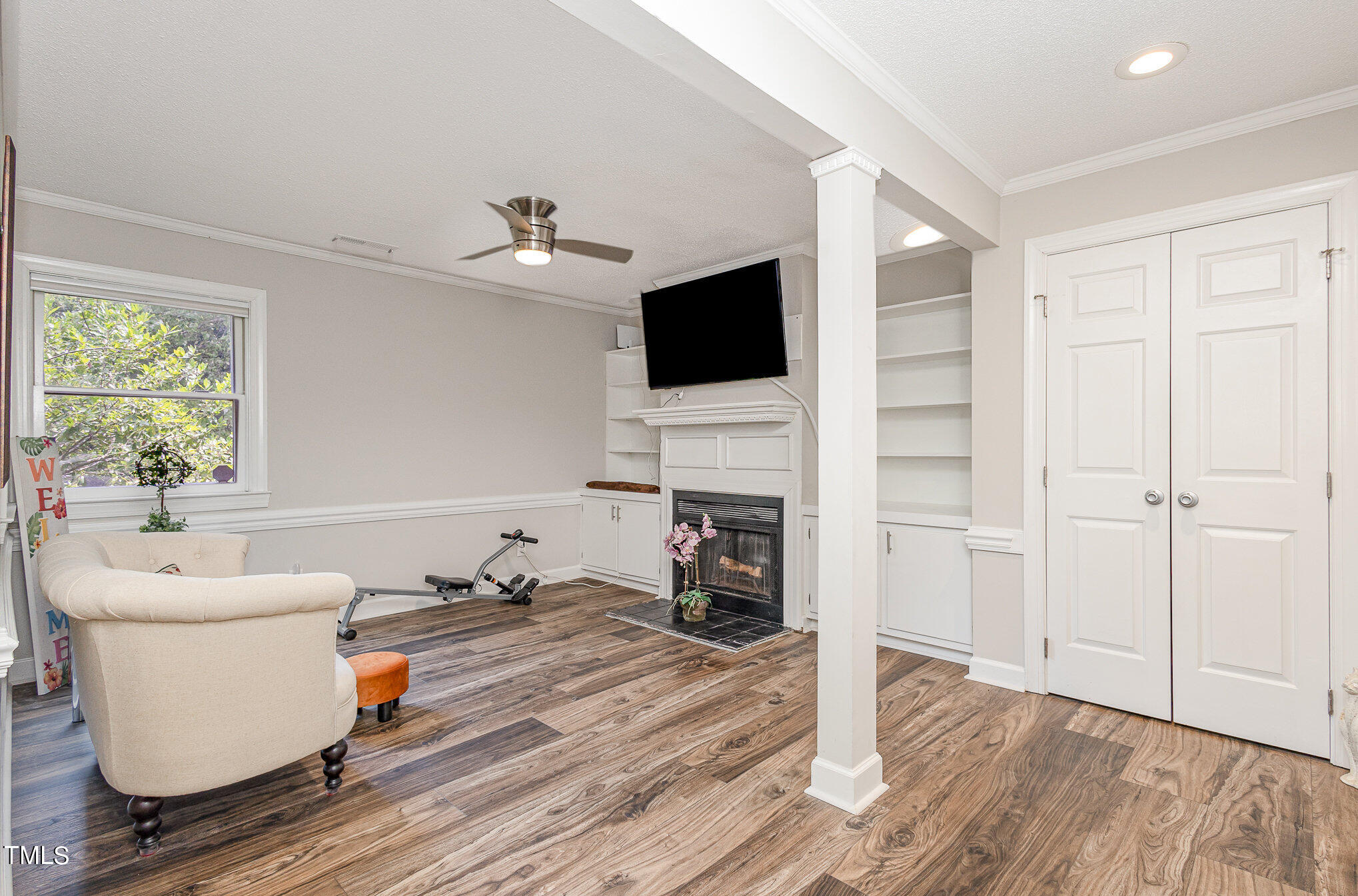 7040 Sandy Forks Road, Unit 203 Raleigh, NC 27615 - Photo 10 of 30 a living room with furniture fireplace and flat screen tv