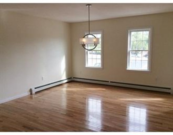 Lot 41-153 Forbes Road Rochester, MA 02770 - Photo 4 of 5 an empty room with wooden floor and windows