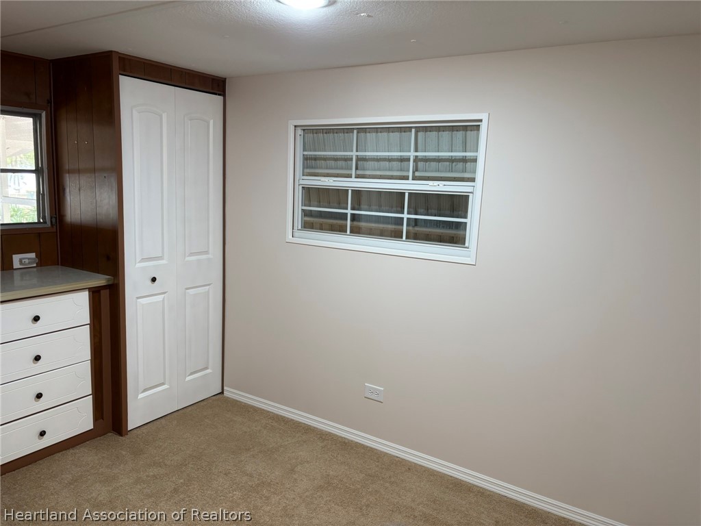 7938 Elliott Road Sebring, FL 33876 - Photo 14 of 20 a view of an empty room with a window