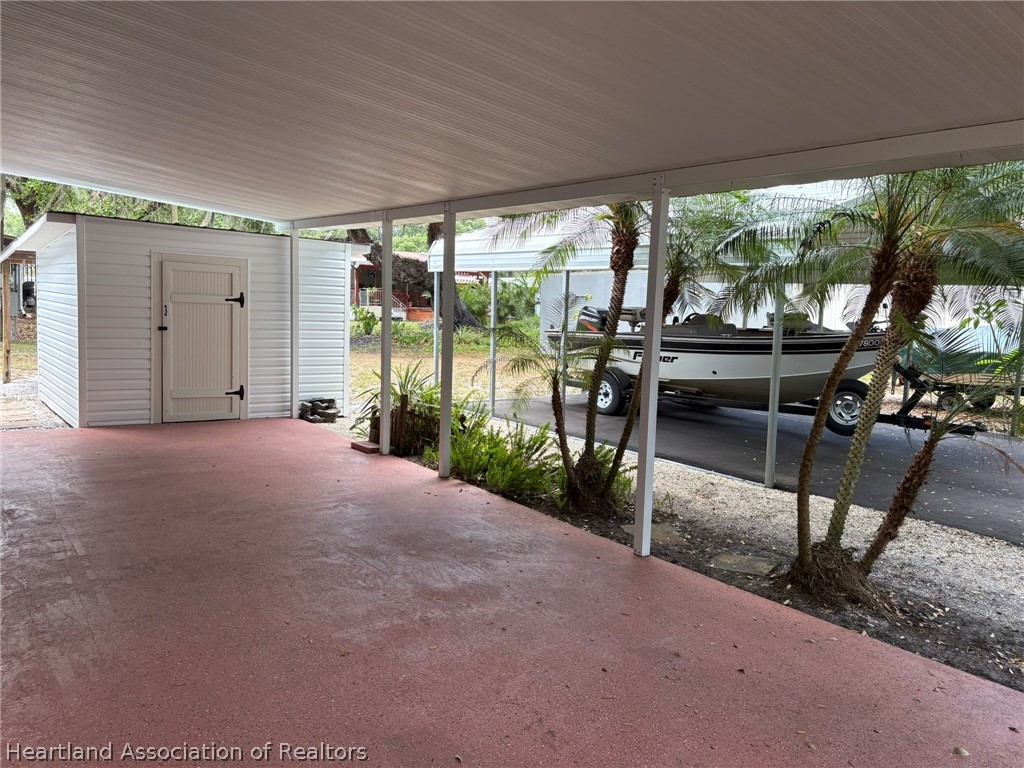 7938 Elliott Road Sebring, FL 33876 - Photo 3 of 20 a view of a porch with chairs and backyard