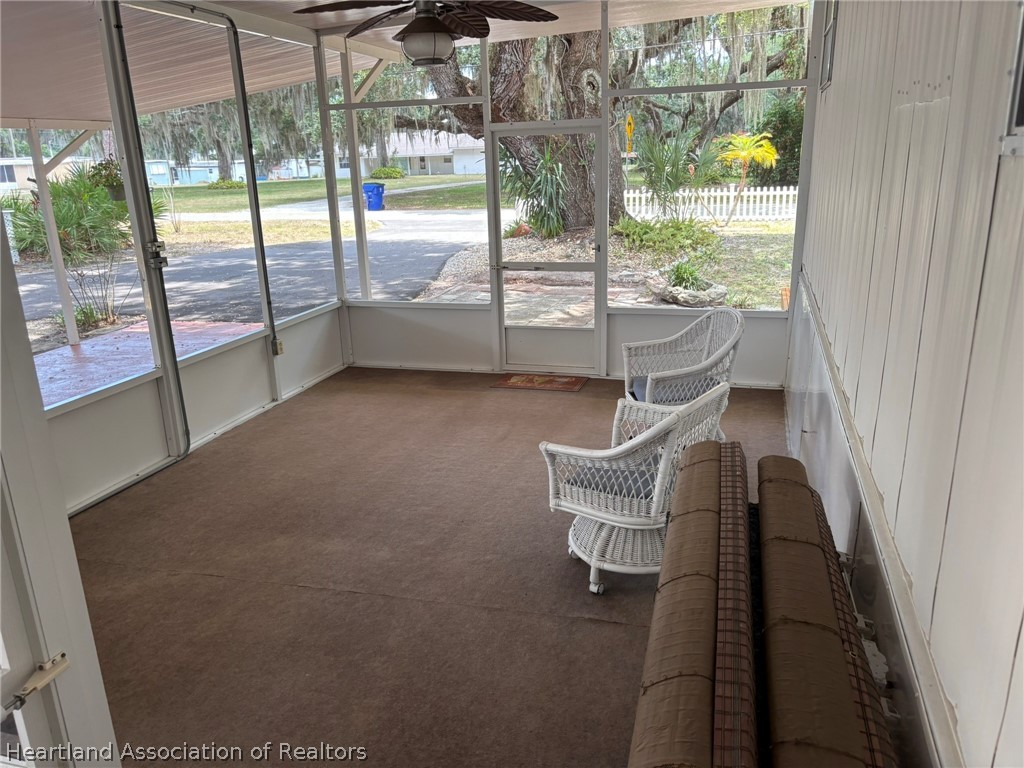 7938 Elliott Road Sebring, FL 33876 - Photo 5 of 20 a living room with furniture and a floor to ceiling window