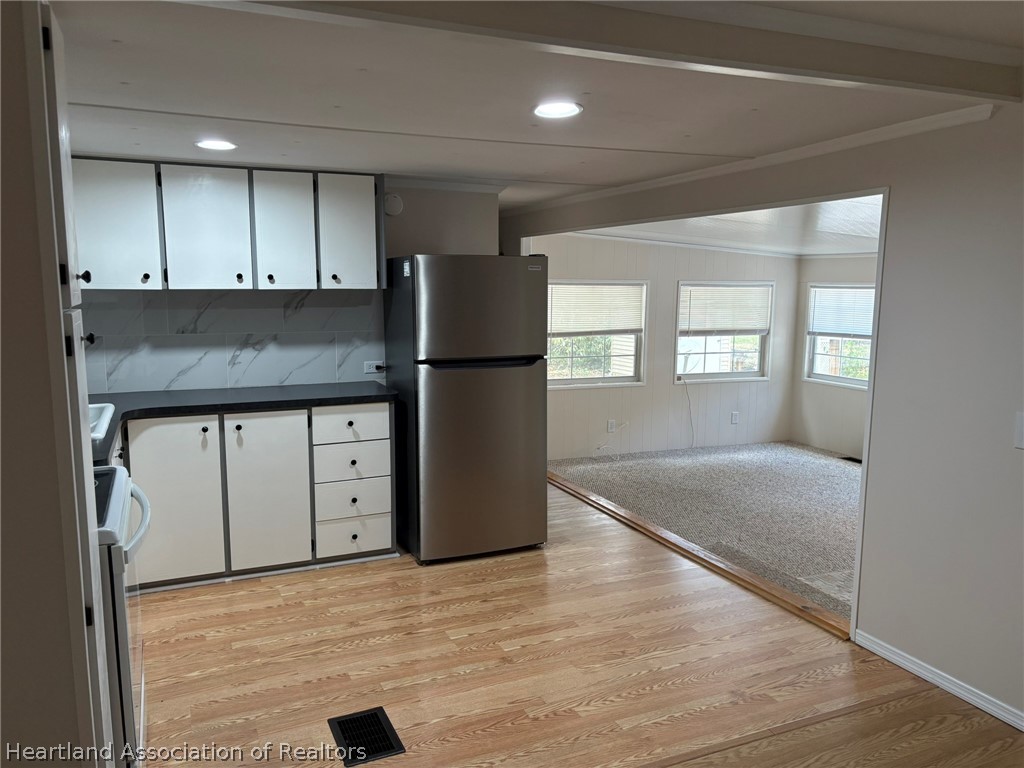 7938 Elliott Road Sebring, FL 33876 - Photo 9 of 20 an empty room with kitchen appliances and windows