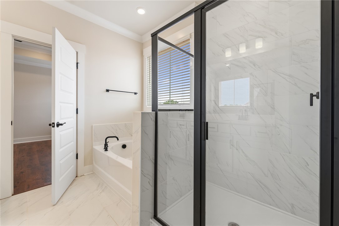 310 Bluestem Court Anderson, SC 29621 - Photo 26 of 36 This spacious owners bath offers a double vanity and a glass-enclosed shower and garden tub creating a serene and functional space.