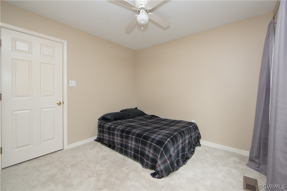 15213 Windy Ridge Road Midlothian, VA 23112 - Photo 7 of 30 a bedroom with a bed and ceiling fan