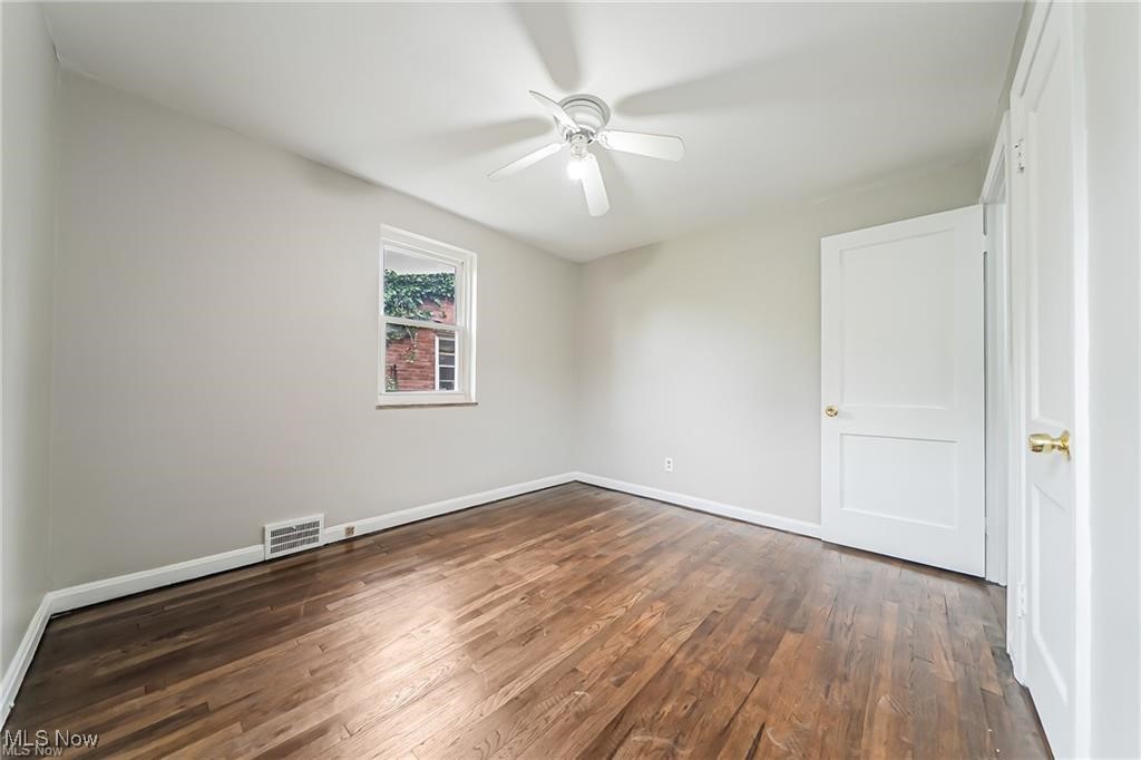 3837 Mayfield Road Cleveland, OH 44121 - Photo 15 of 29 Spare room featuring dark wood-type flooring and ceiling fan