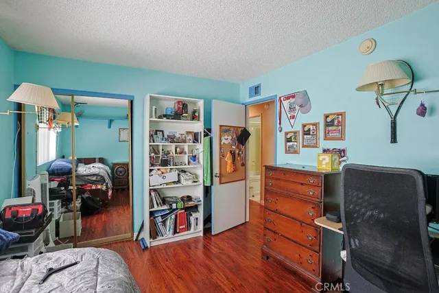 a bedroom with furniture and a closet