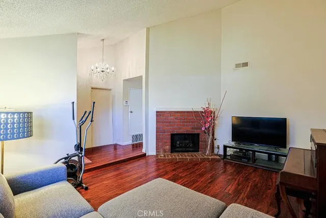 a living room with furniture flat screen tv and a fireplace
