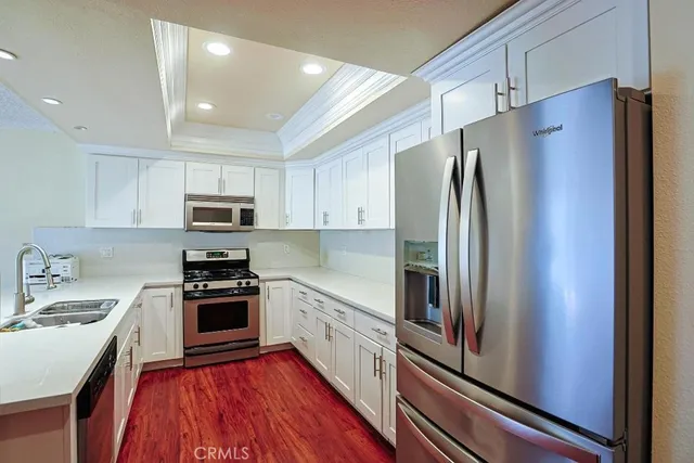 a kitchen with stainless steel appliances a refrigerator sink and stove