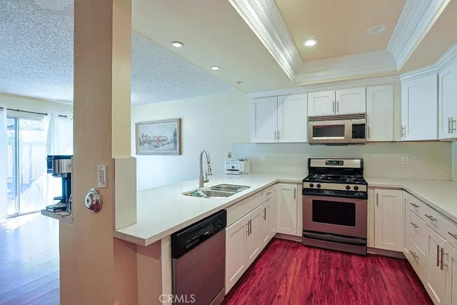 a kitchen with a sink stove and microwave