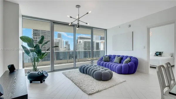 a bedroom with furniture and a large window