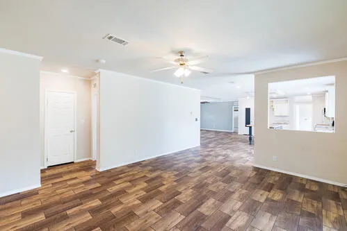 a view of a livingroom with a ceiling fan and wooden floor
