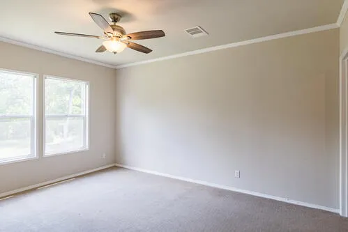 a view of a small space with wooden floor and a window