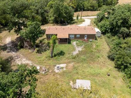a aerial view of a house with yard and sitting area