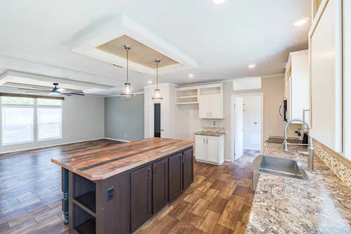 a kitchen with a stove a refrigerator and wooden floor