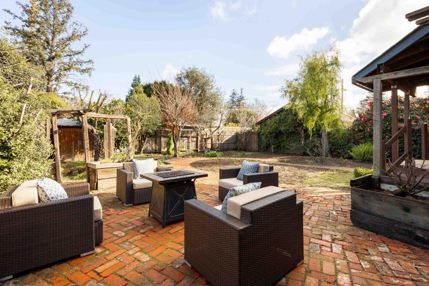 104 Clover Lane Menlo Park, CA 94025 - Photo 25 of 26 a view of a patio with couches chairs and a fire pit