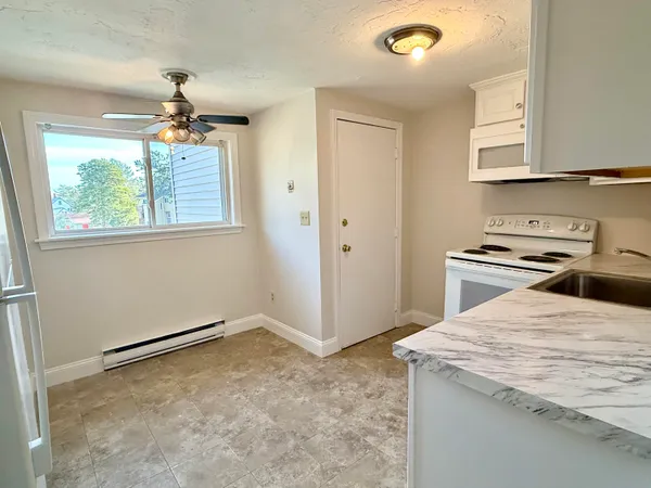 a kitchen with a stove a sink and a refrigerator