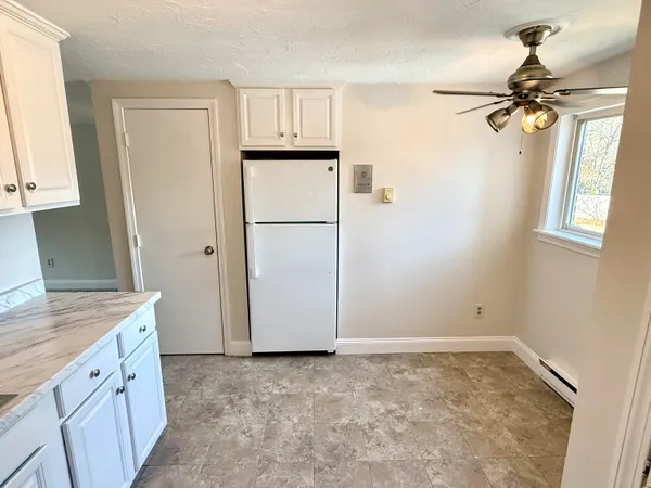 a view of a kitchen with a sink and cabinet