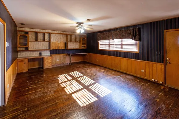 a view of a room with wooden floor and window